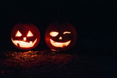 two lighted jack-o-lanterns during night time